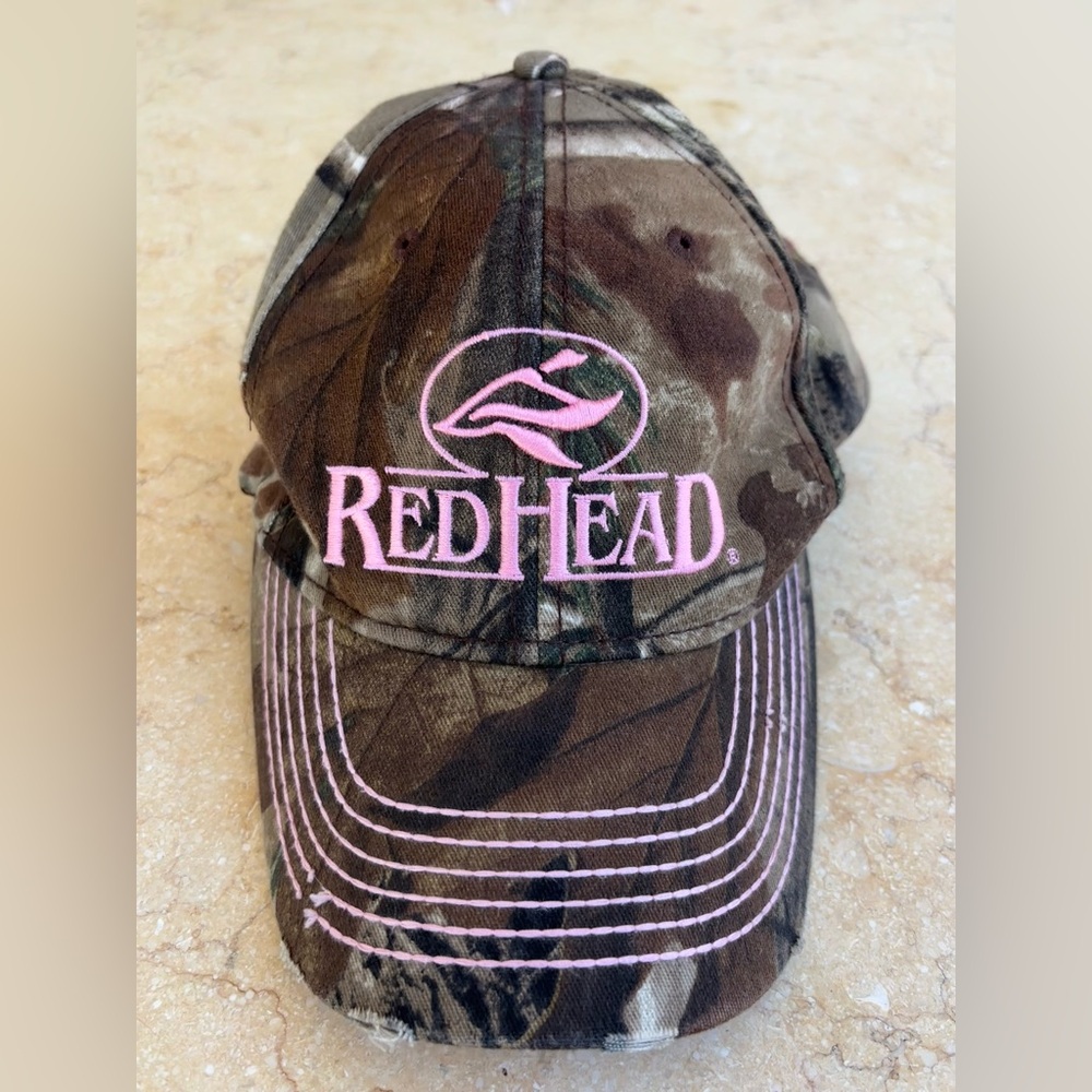 red head camo and pink baseball cap